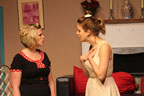 A woman in a black dress talking to a woman in a white dress
