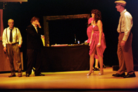 A man with a moustache, a man covering his face with his hand, a woman in a slit skirt, and a man
        in a cap